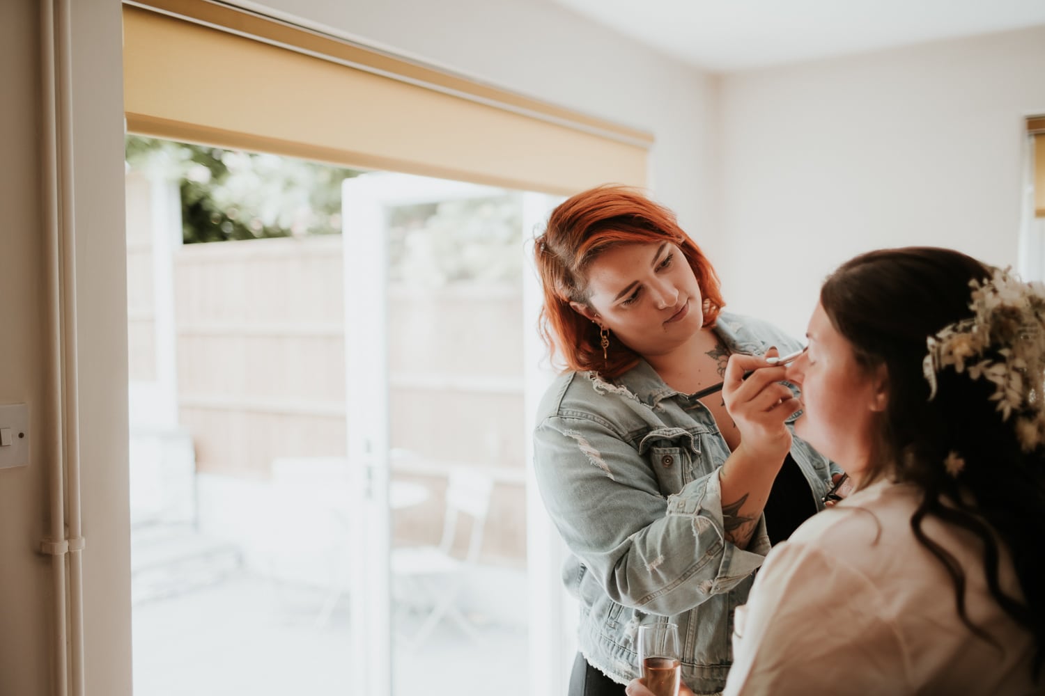 Bride having her make up applied