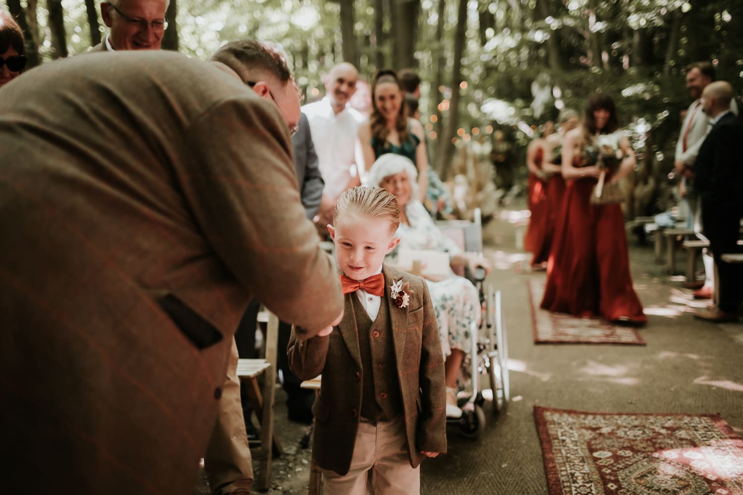 Groom fist bumping a page boy