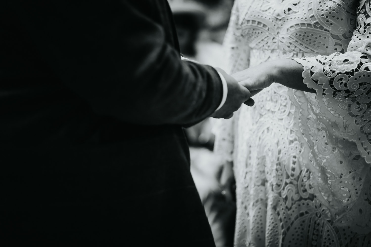 Bride and groom holding hands whilst getting married at The Dreys