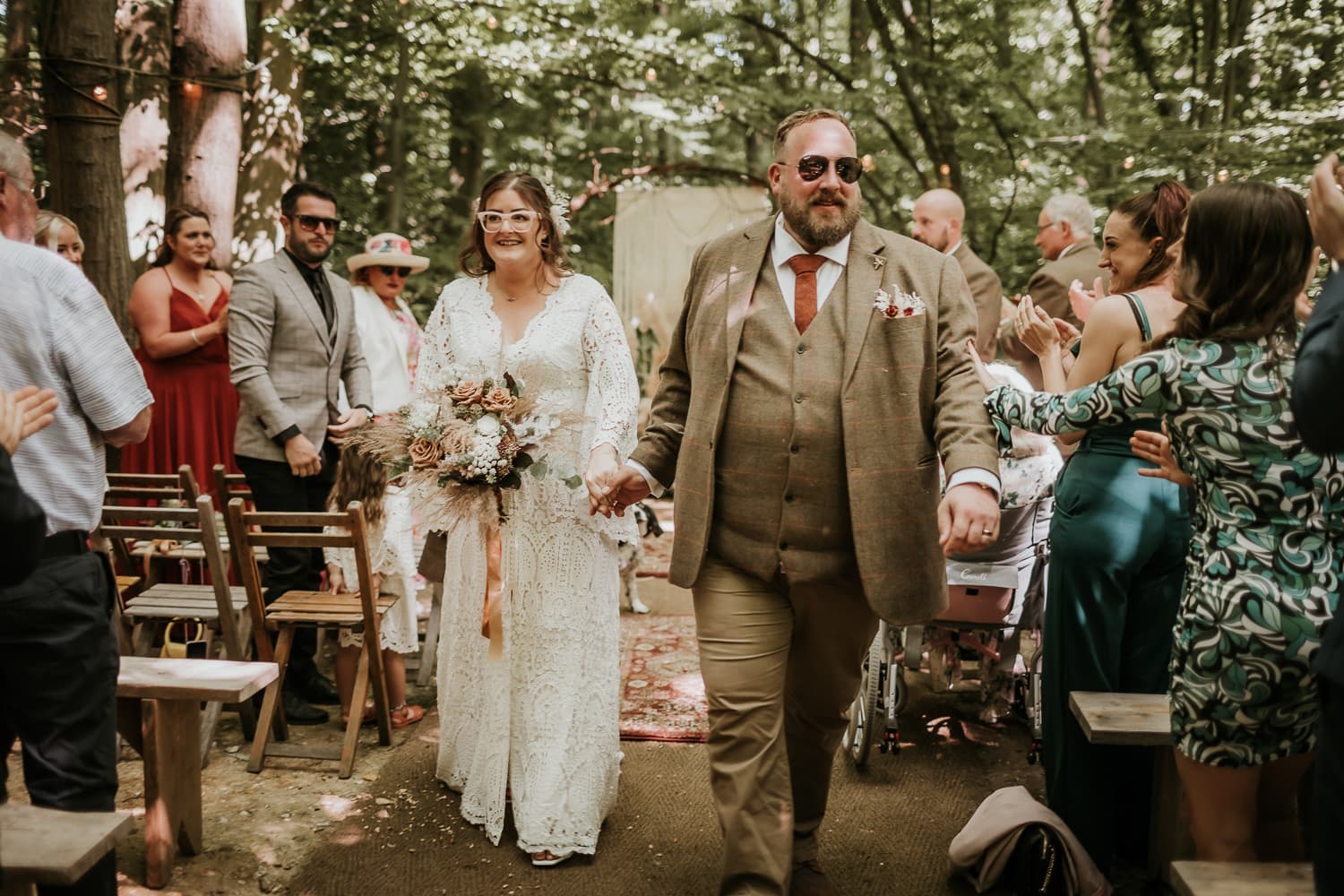 Bride and groom walking down the aisle after getting married