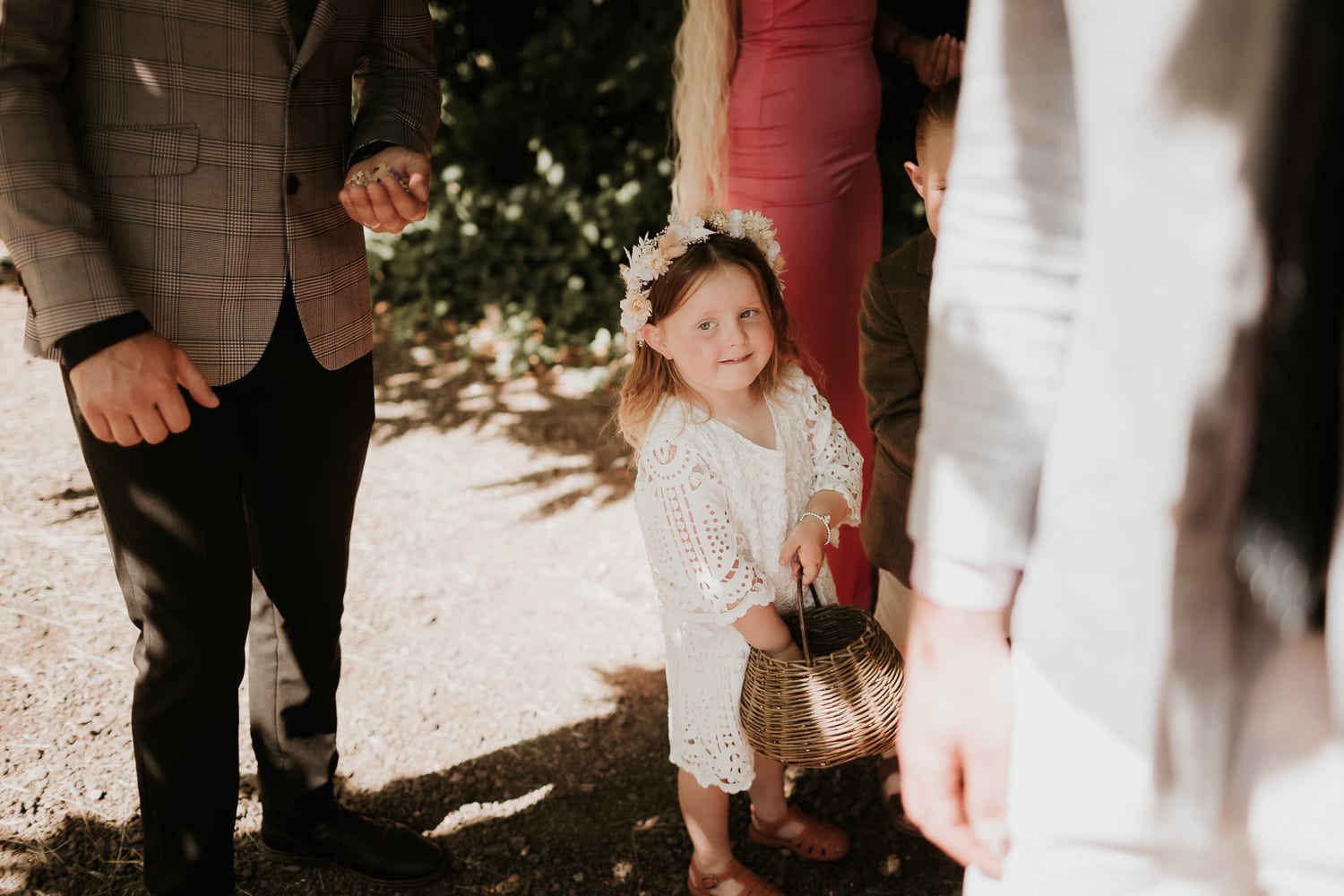 Flower girl smiling whilst waiting to throw confetti