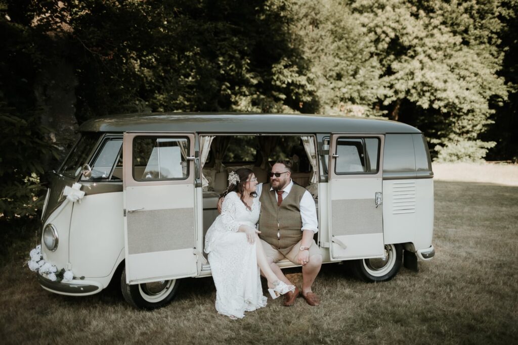 Bride and groom sat in a vintage VW camper van