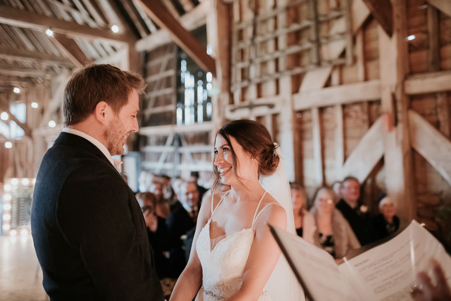 Bride and groom inside a barn having their wedding ceremony