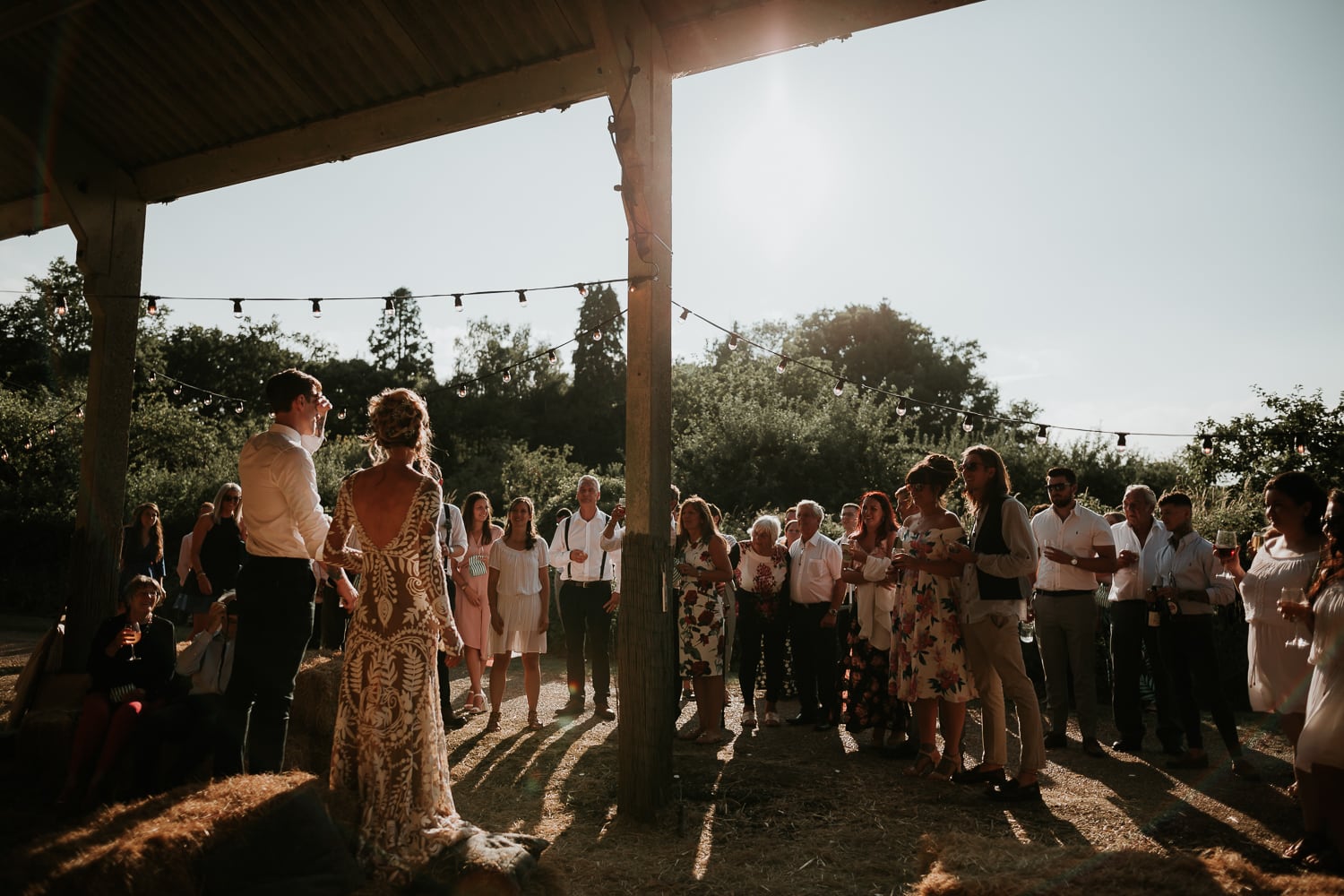 Couple giving a wedding speech in the Dutch Barn at The Great Barn Rolvenden